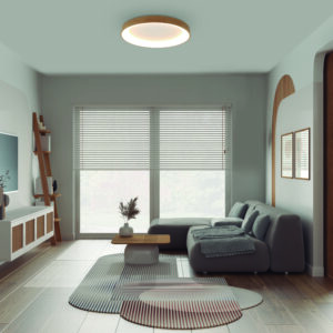 Modern wooden living room in white tones, velvet sofa with carpet and side table, rattan commode with television. Big window with blinds, parquet and cane ceiling. Interior design